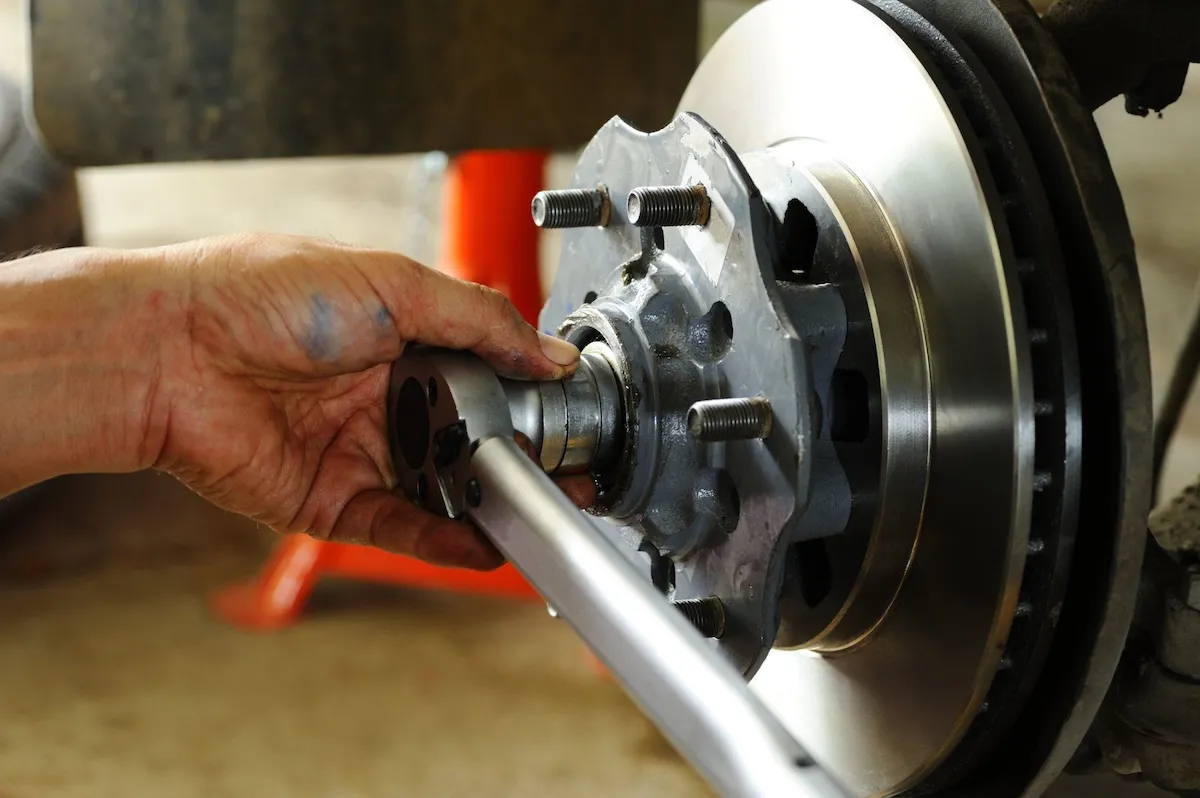Mechanic torquing a wheel hub on a disc brake rotor at Knights Brake Specialists