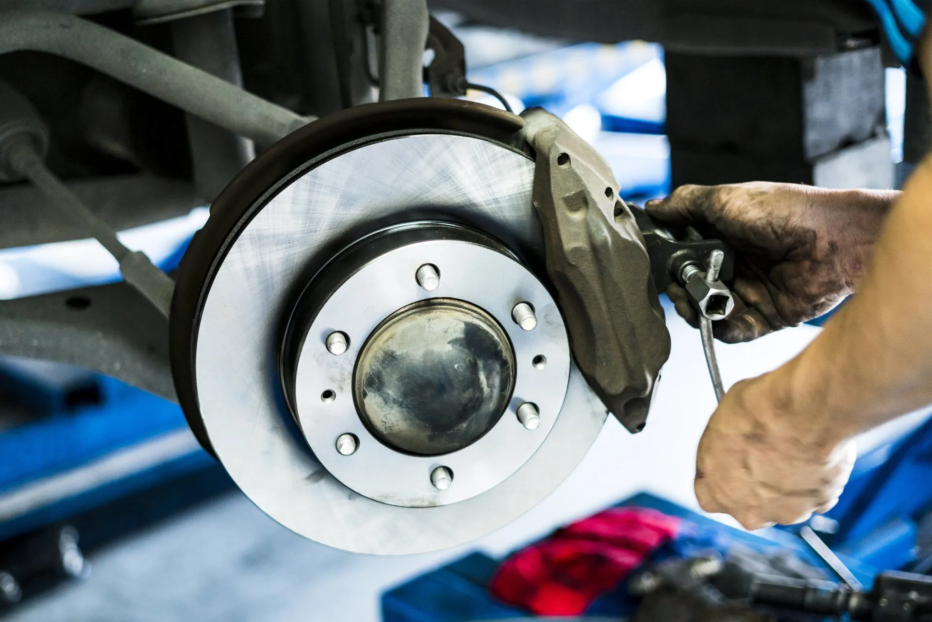 Mechanic removing a brake caliper from a freshly machined disc rotor