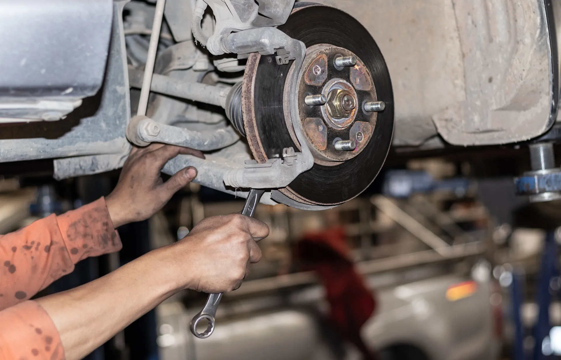 Close-up of a brake disc rotor and caliper on a vehicle at the Knights Brake Specialists workshop
