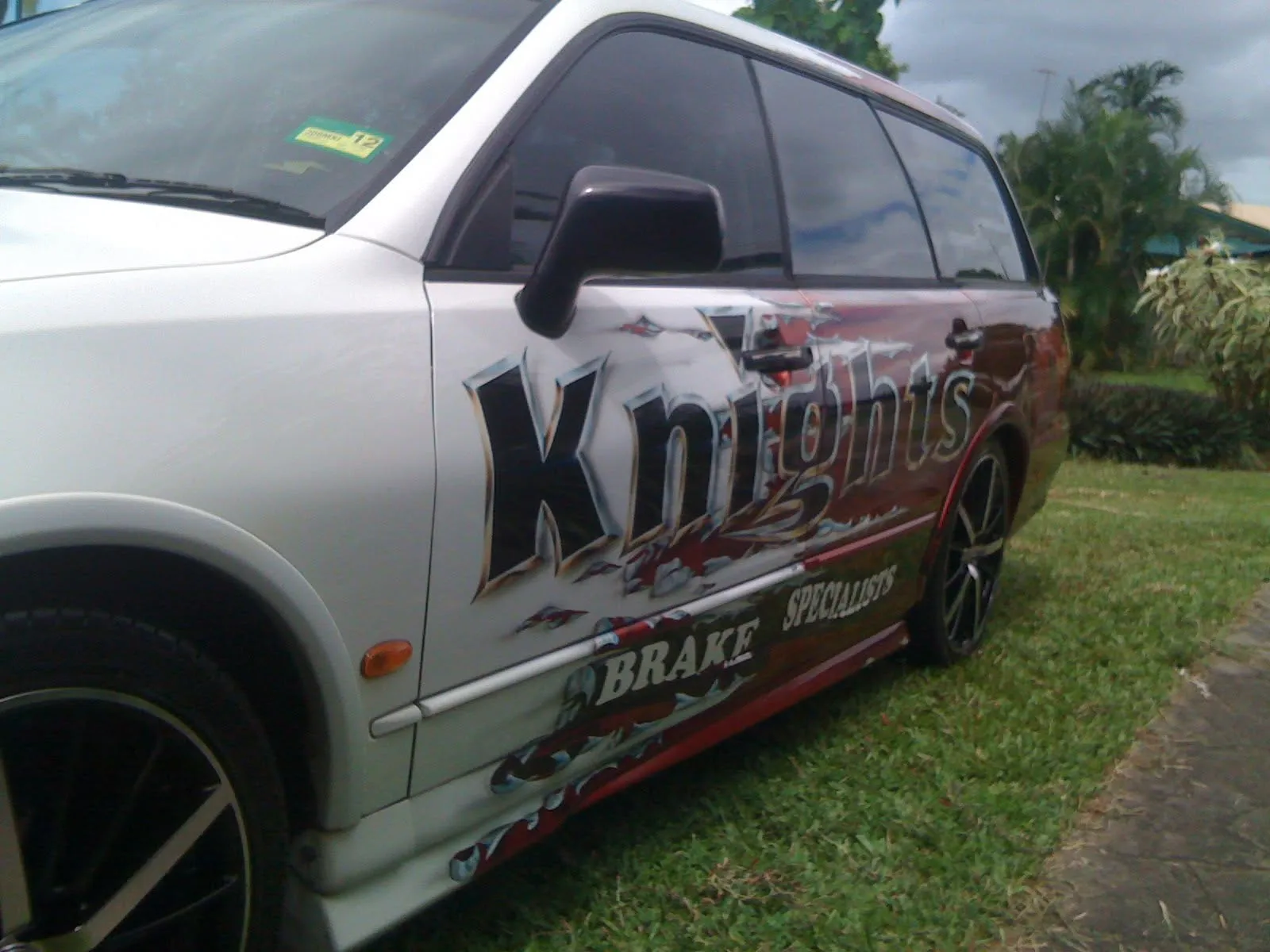 Nissan wagon with Knights Brake Specialists livery parked at the Cairns workshop