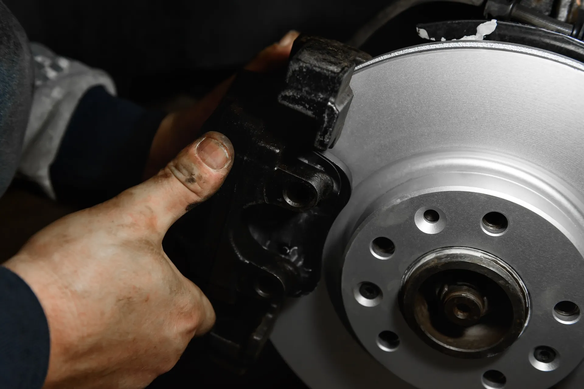 Mechanic removing a brake caliper from a freshly machined disc rotor